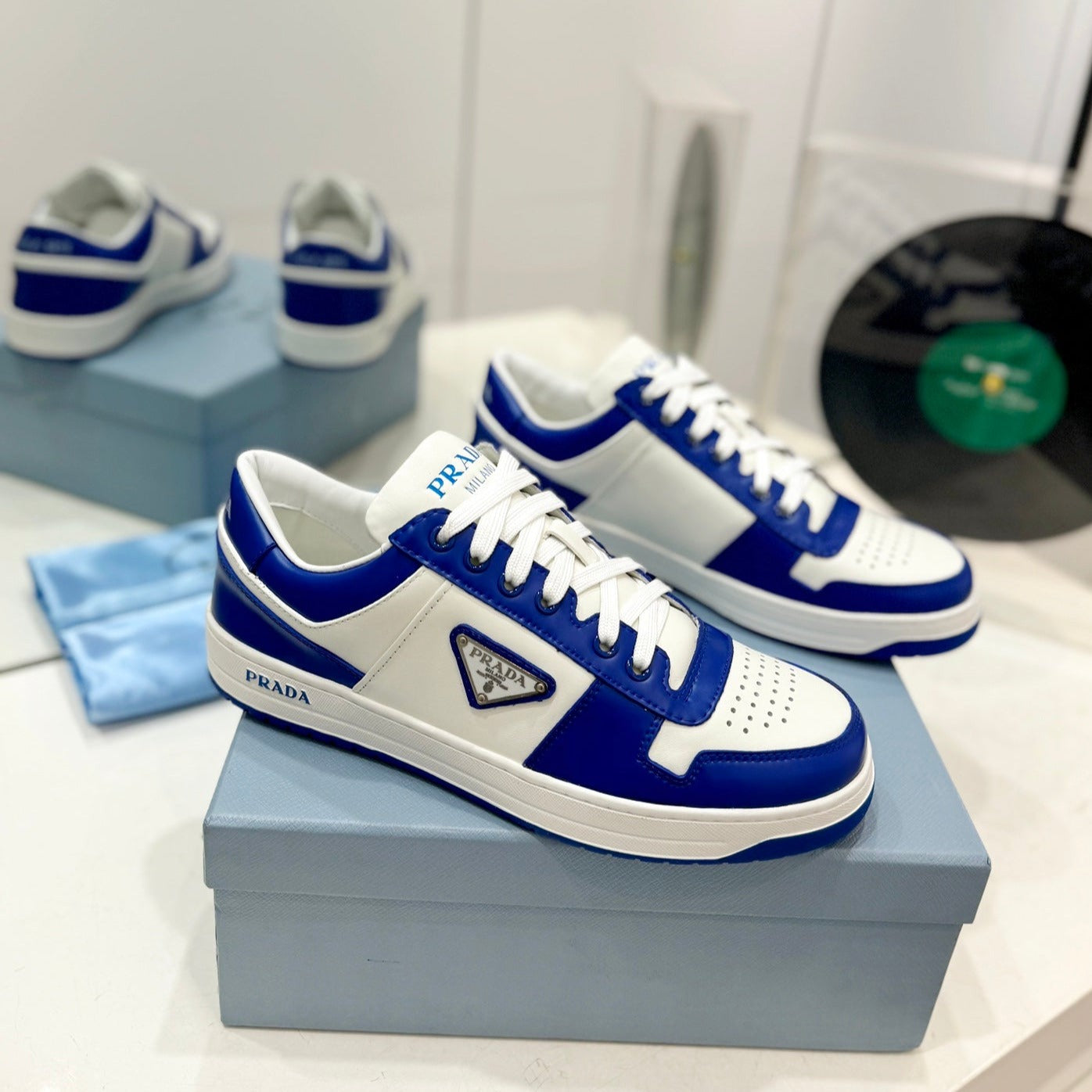 Luxury PradaDOWNTOWN PERFORATED SNEAKERS WHITE AND COBALT CALFSKIN