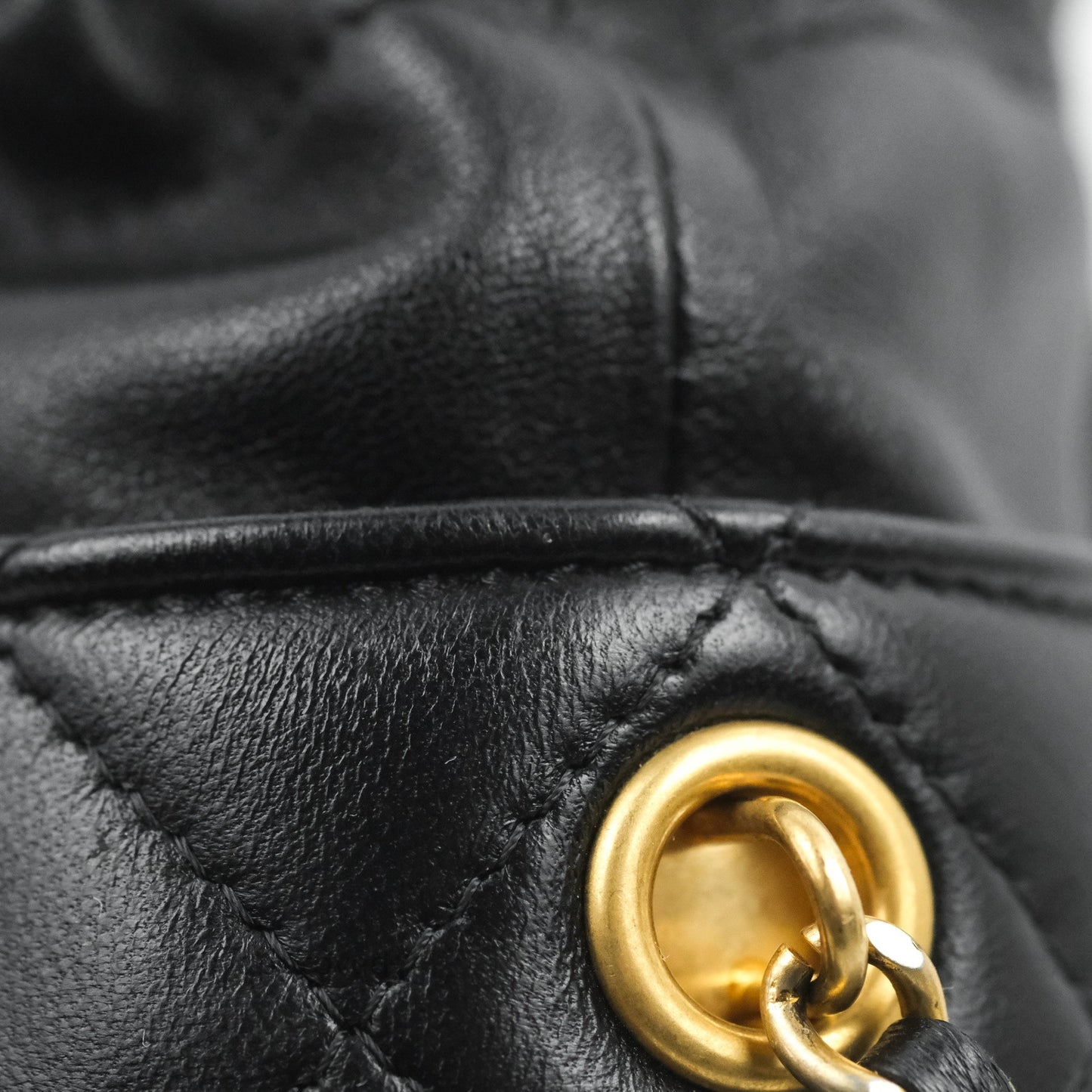 Chanel Quilted Drawstring Pearl Flower Bucket Bag Black Lambskin Aged Gold Hardware