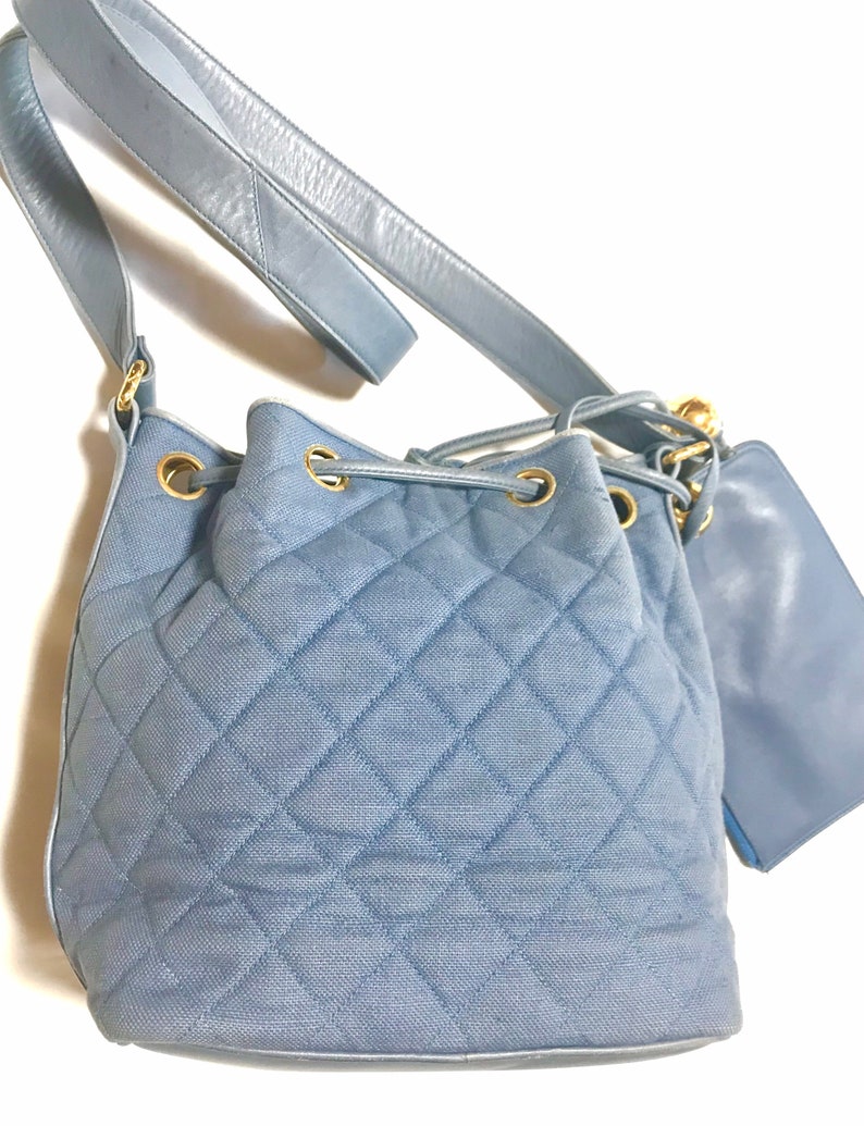 Luxury Chanel Vintage blue quilted canvas and leather combo hobo bucket shoulder bag with drawstrings and golden CC mark balls